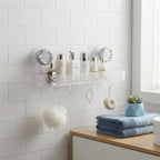 Transparent acrylic bathroom shelf mounted on white tiles holding heavy shampoo bottles in a modern apartment bathroom.